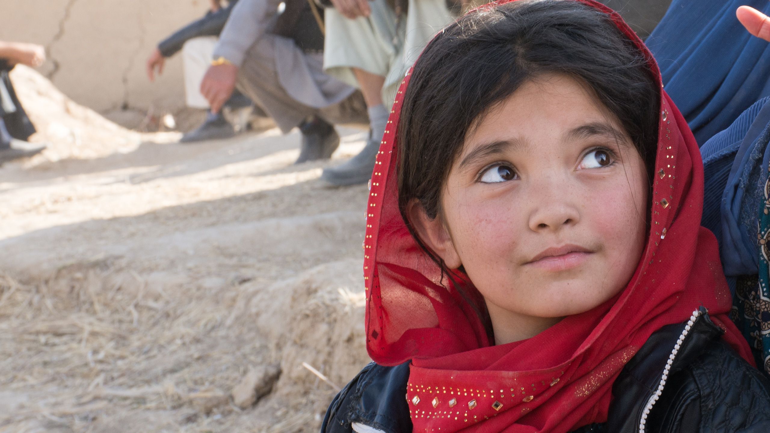 NRC / Enayatullah Azad, Start Fund alert 199 Afghanistan conflict displacement. Displaced families from Tebar village live in Sar-e-pul city. Sorya, 12, (in red) was living in the open outside of the DoRR center. December 2017.