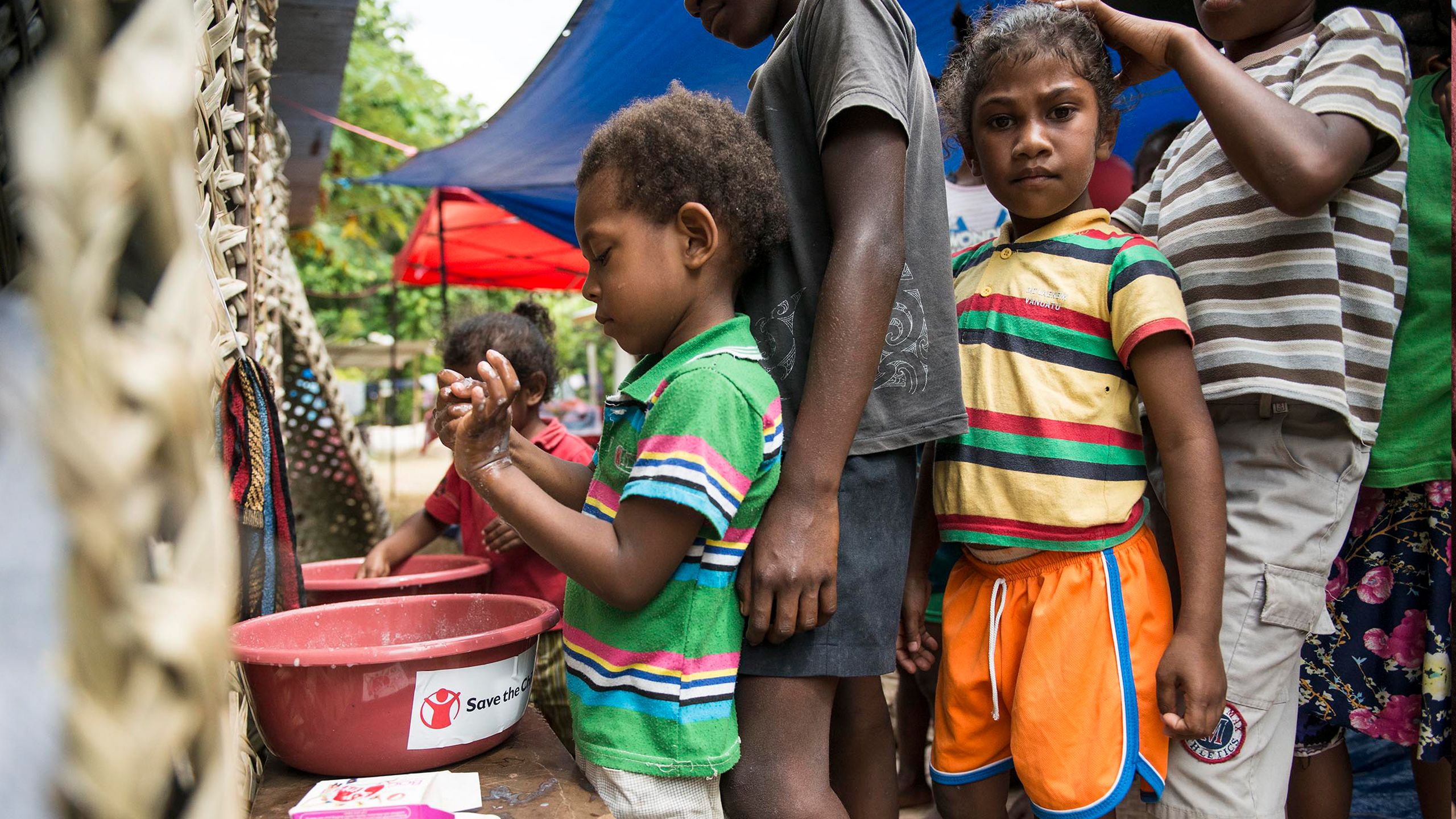 Children displaced due to volcanic activity on Ambae island practice good hygiene at a child friendly space.
