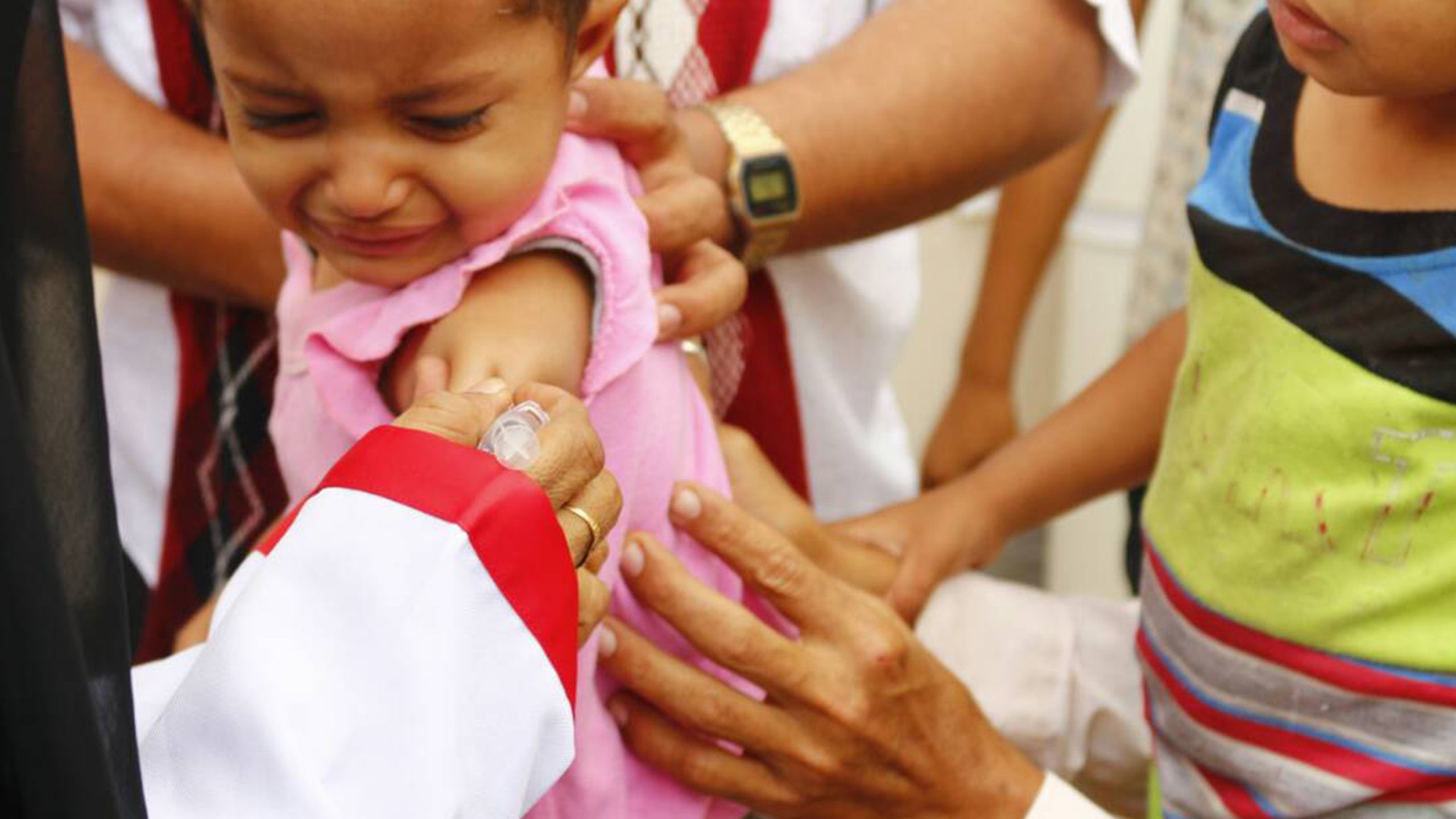 A young girl is seen being vaccinated against diphtheria.